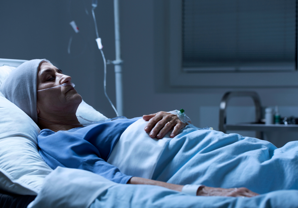 Hospital room, elderly patient in headscarf, bed with oxygen and IV, low light, documentary style, one person.